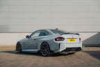 TREVORA G87 M2 carbon fiber rear spoiler installed on a vehicle, enhancing aerodynamics and sporty exterior appearance.