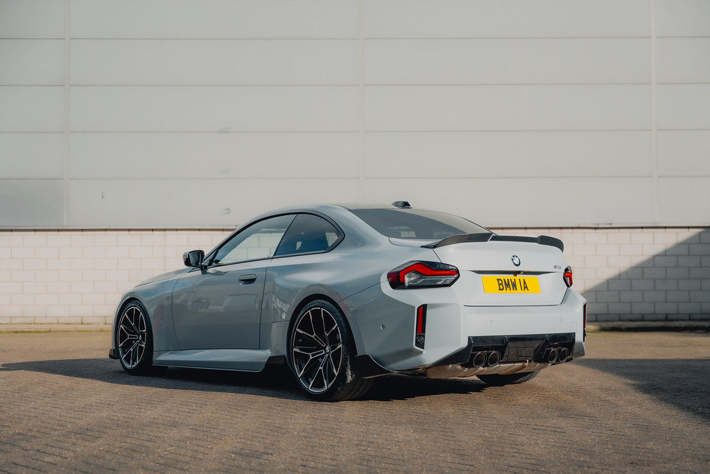 TREVORA G87 M2 carbon fiber rear spoiler installed on a vehicle, enhancing aerodynamics and sporty exterior appearance.
