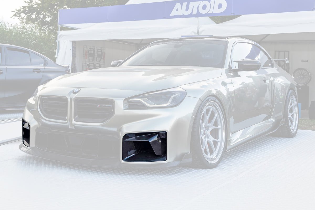TREVORA G87 M2 carbon front air duct set installed on a car exterior, showcasing sleek aerodynamic design and high-performance materials.