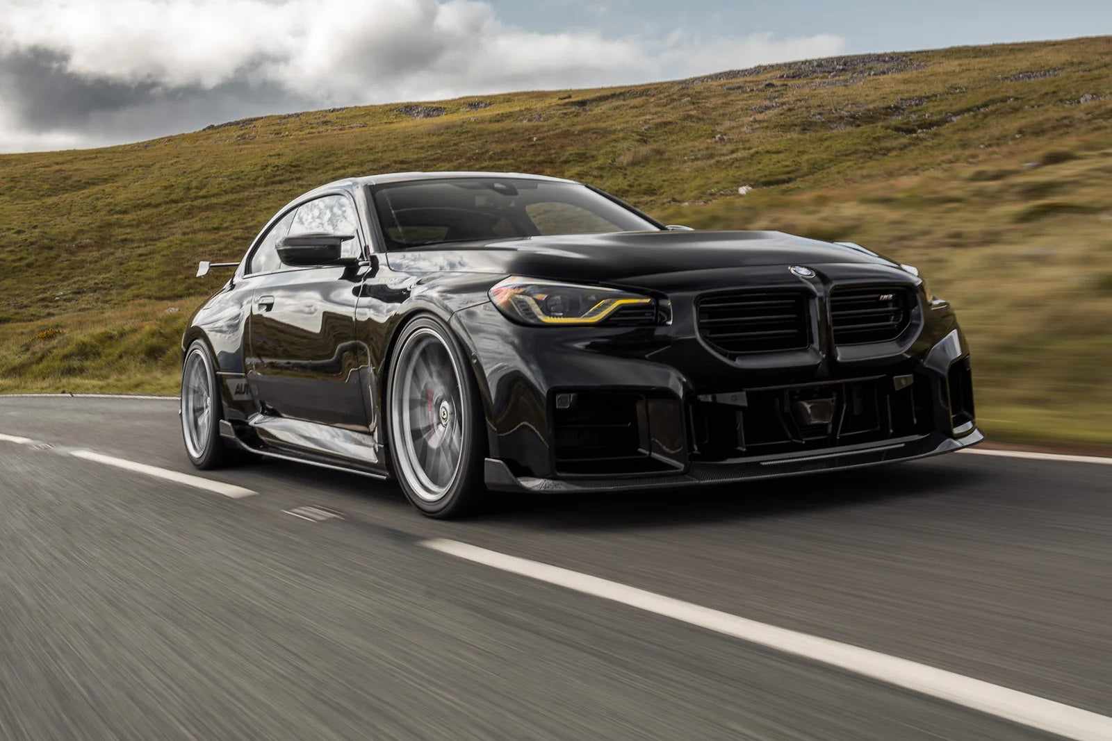 TREVORA G87 M2 Carbon side skirt set installed on a BMW G87 M2 exterior car enhancement.