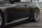 TREVORA G87 M2 Carbon side skirt set installed on a car, showcasing sleek exterior design and aerodynamic features.