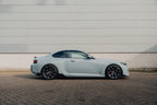 TREVORA G87 M2 carbon side skirt set installed on a car's exterior, showcasing sleek, aerodynamic design.