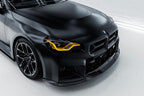 TREVORA G87 M2 TR87 carbon flat front splitter installed on the exterior of a vehicle, showcasing its sleek aerodynamic design.