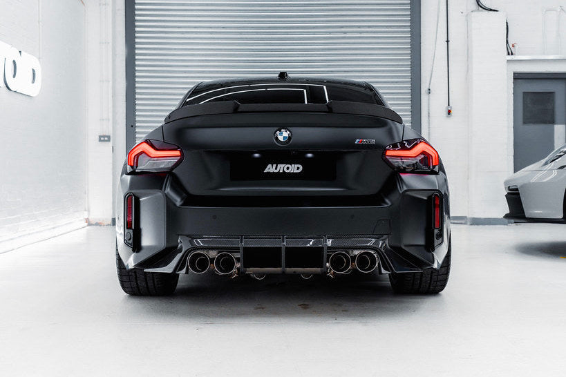 TREVORA G87 M2 TR87 carbon rear diffuser installed on a car, highlighting sleek exterior design and lightweight aerodynamic features.