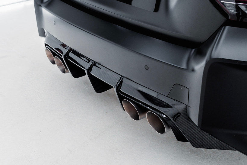 TREVORA G87 M2 TR87 carbon rear diffuser installed on a car, showcasing its sleek, aerodynamic exterior design.