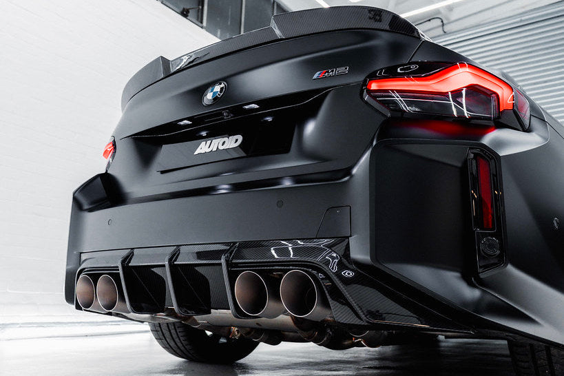 TREVORA G87 M2 TR87 carbon rear diffuser installed on the exterior of a vehicle, showcasing its sleek, aerodynamic design.