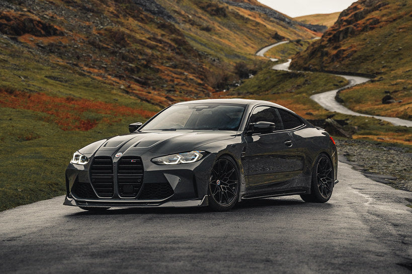 TREVORA G8X M3 M4 carbon fiber front splitter installed on vehicle, showing detailed exterior design and aerodynamic features.