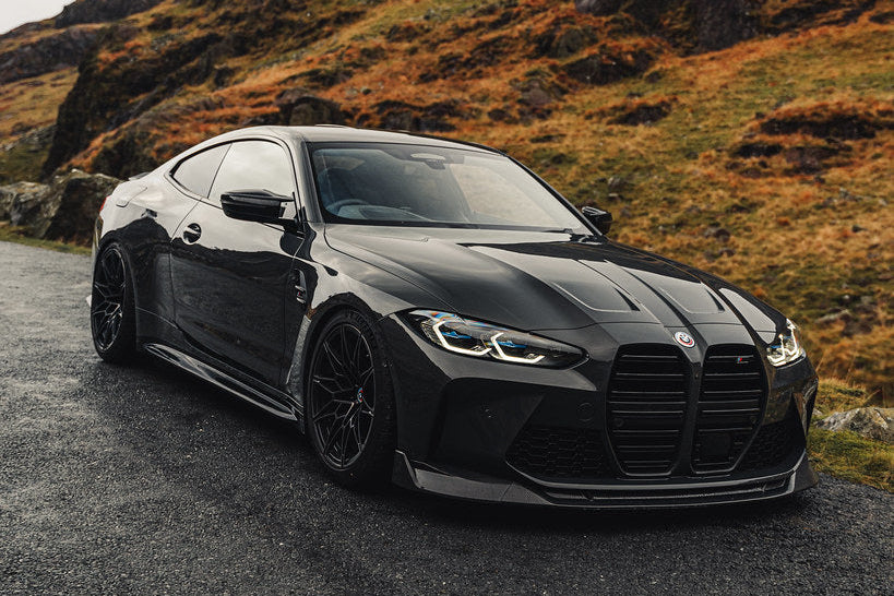 TREVORA G8X M3 M4 carbon fiber front splitter installed on vehicle, showcasing the sleek exterior design and aerodynamic features.