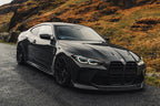 TREVORA G8X M3 M4 carbon fiber front splitter installed on vehicle, showcasing the sleek exterior design and aerodynamic features.