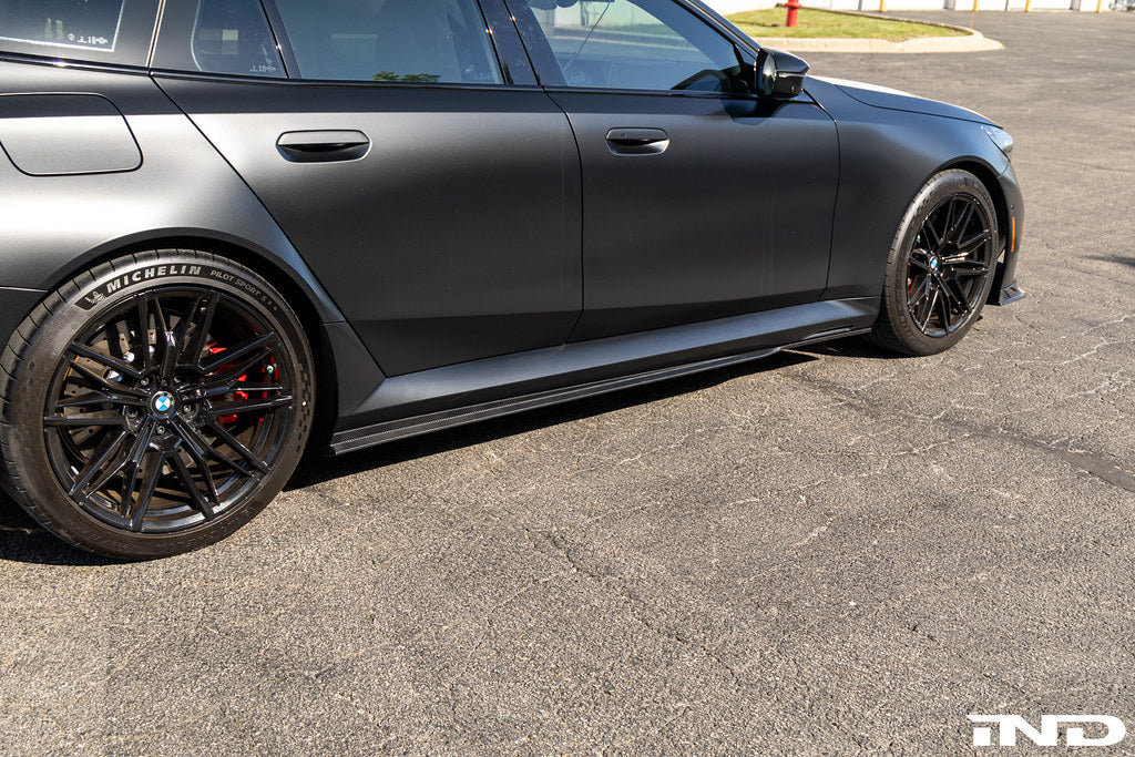TREVORA G90 G99 M5 carbon fiber side skirts installed on a vehicle, showcasing sleek exterior design and aerodynamic enhancement.