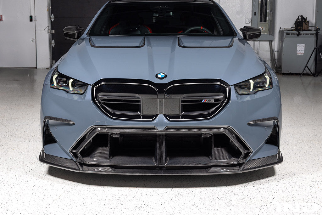 TREVORA G90 G99 M5 carbon fiber front duct extension trims installed on exterior of vehicle, showcasing sleek, aerodynamic design.