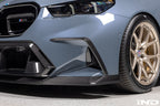 TREVORA G90 G99 M5 carbon fiber front duct extension trims installed on exterior of vehicle, showcasing sleek, aerodynamic design.