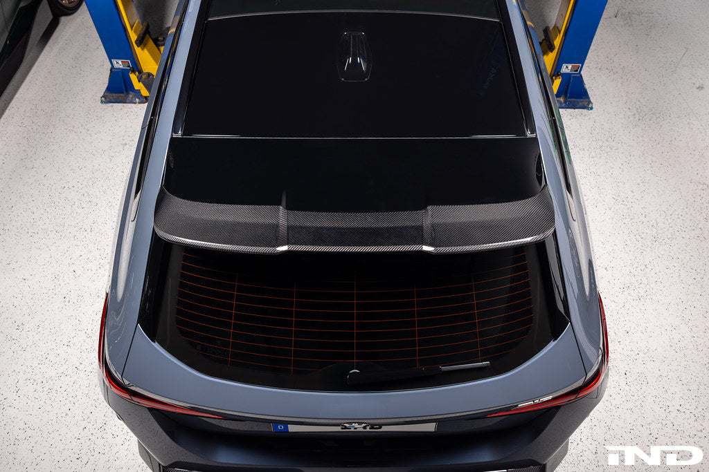 TREVORA G99 M5 carbon fiber rear roof spoiler installed on a vehicle, showcasing sleek exterior design and aerodynamic enhancements.