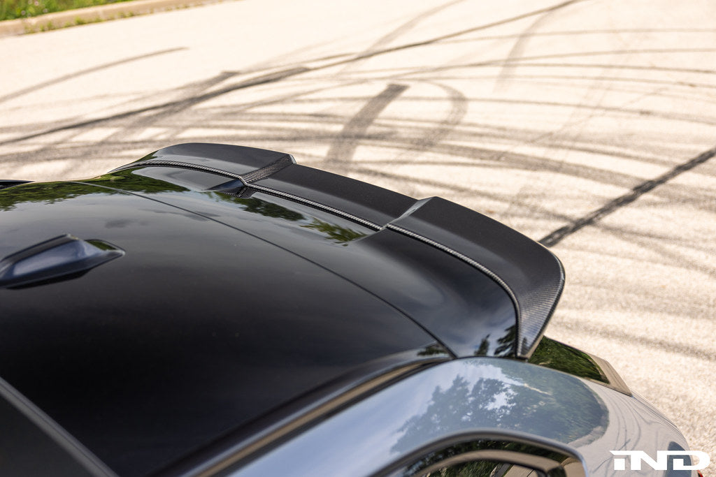 TREVORA G99 M5 Carbon Fiber PR-1 rear roof spoiler installed on a vehicle, showcasing sleek exterior design and aerodynamic style.