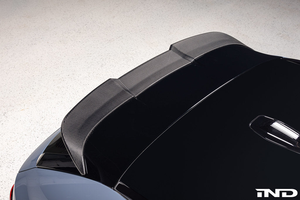 TREVORA G99 M5 Carbon Fiber PR-1 rear roof spoiler installed on a car, showcasing sleek, aerodynamic exterior design.