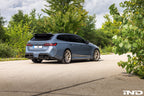TREVORA G99 M5 carbon fiber rear roof spoiler installed on a vehicle, showcasing sleek exterior design and aerodynamic enhancement.