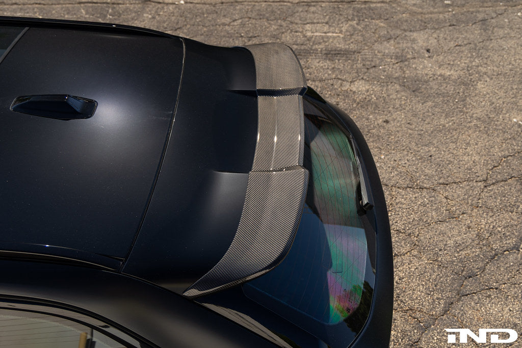 TREVORA G99 M5 Carbon Fiber Rear Roof Spoiler installed on vehicle, showing sleek exterior design and aerodynamic features.