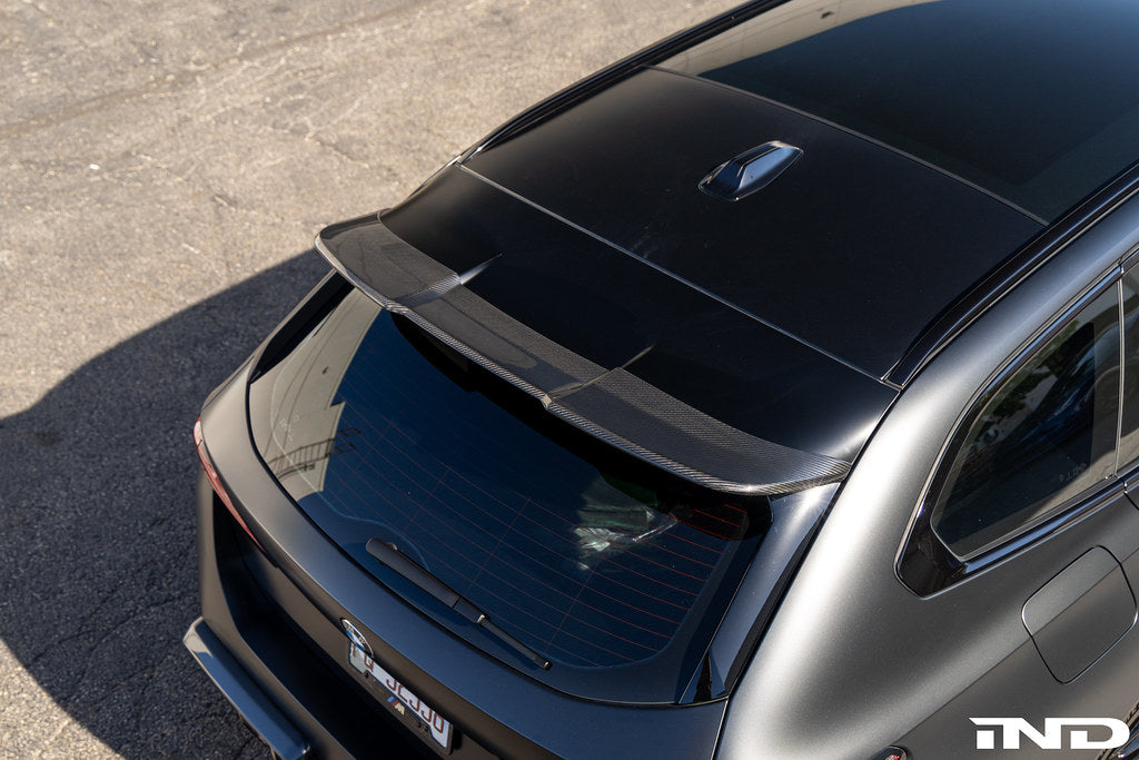 TREVORA G99 M5 Carbon Fiber PR-1 rear roof spoiler installed on a car, showcasing sleek aerodynamic exterior upgrade.