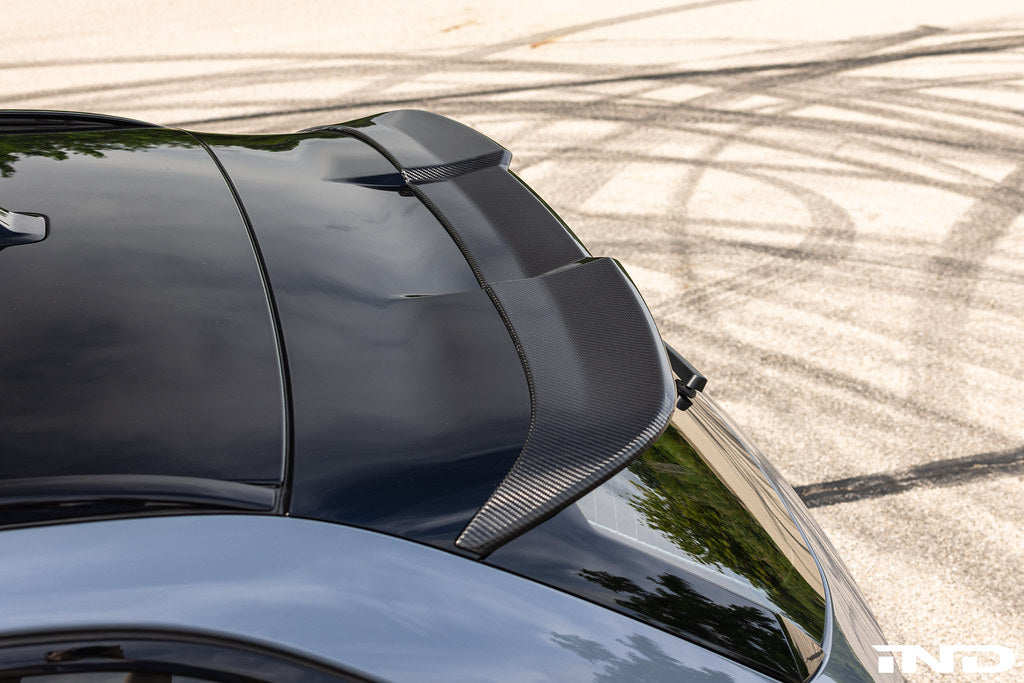 TREVORA BMW G90 G99 M5 PR-1 carbon exterior body kit with rear roof spoiler installed on the vehicle.