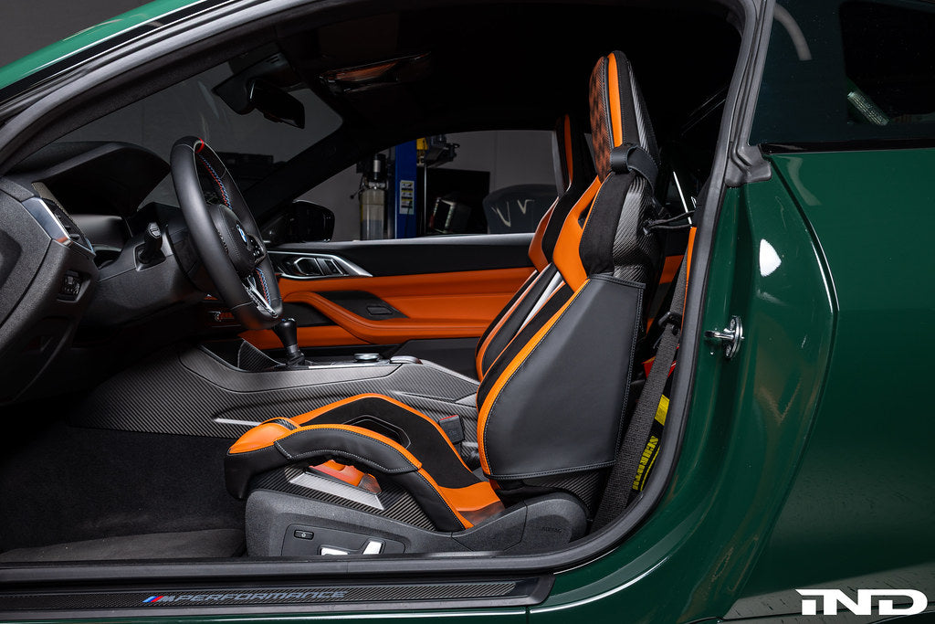 Wunderworks BMW M Carbon bucket seat upper bolster protector set installed in interior, showing black carbon fiber protectors on seat bolsters.