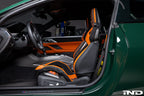 Wunderworks BMW M Carbon bucket seat upper bolster protector set installed in interior, showing black carbon fiber protectors on seat bolsters.