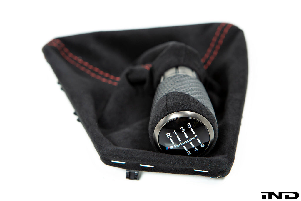 IND F87 M2 matte carbon stitched shift boot for 6-speed manual interior, featuring premium carbon and detailed stitching.