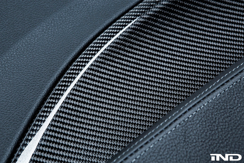 Alpha N F87 M2 interior carbon door card set installed, showcasing sleek black carbon fiber finish on vehicle door panels.