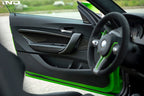 Alpha N F87 M2 carbon interior door card set installed in a vehicle, showcasing sleek black carbon fiber finish and detailed craftsmanship.