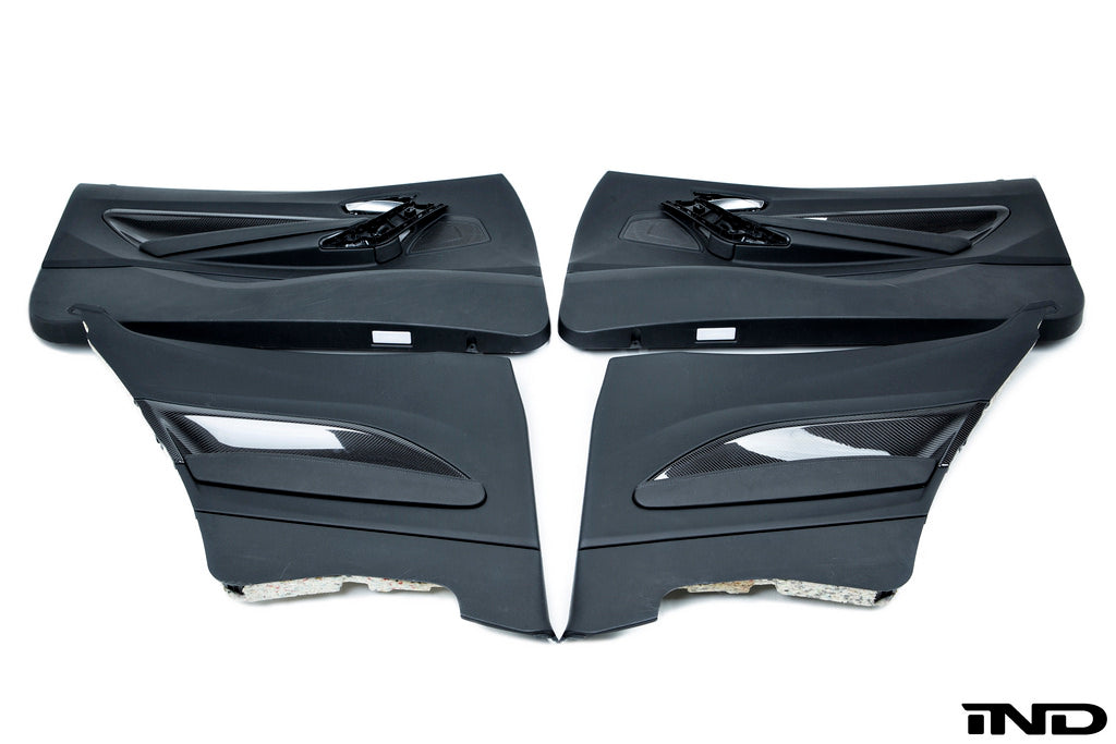 Alpha N F87 M2 carbon door card set for interior, featuring sleek white finish and detailed craftsmanship on the door panels.