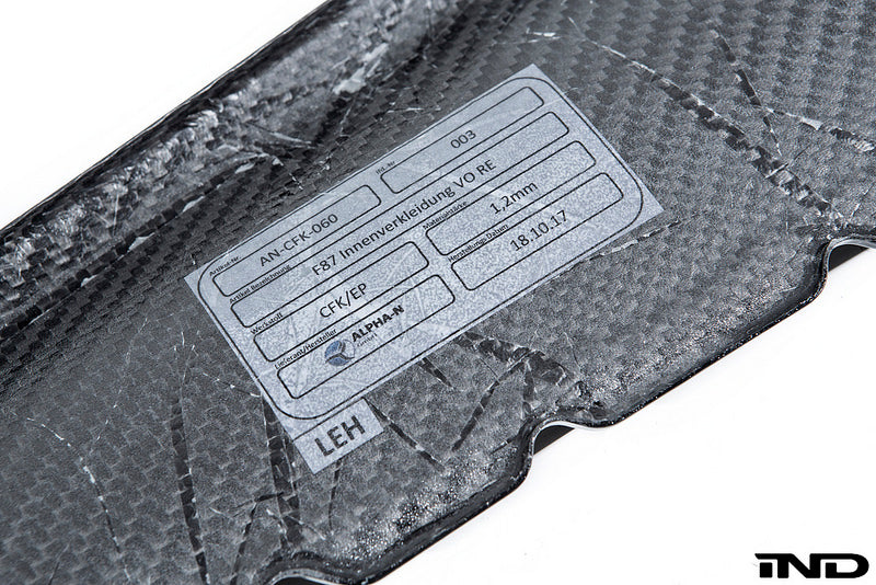 Alpha N Alpha-N F87 M2 carbon interior door card set with white background, showcasing sleek, lightweight carbon fiber panels.