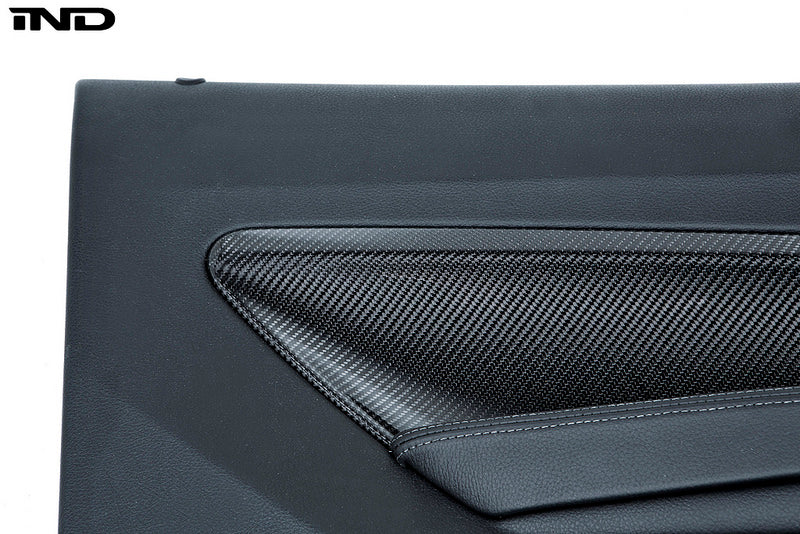 Alpha N F87 M2 interior carbon door card set with white background, showcasing sleek, lightweight carbon fiber finish and detailed design.
