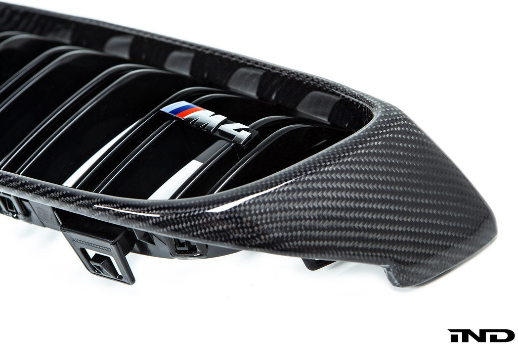 IND Carbon Fiber Front Grille Set for BMW F80 M3 and F82/F83 M4 featuring 2x2 carbon fiber surrounds with OEM BMW grille slats on a white background.
