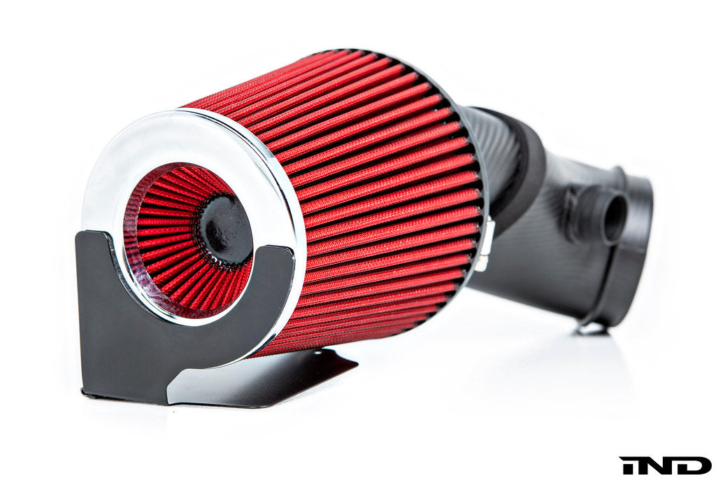 Close-up view of Eventuri filter element installed on their E9X M3 matte carbon intake system duct on a white background