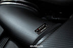 Close-up view of Eventuri matte carbon intake system duct connecting airbox and plenum installed in an E9X M3.
