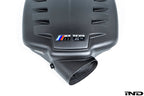 Eventuri black carbon fiber inlet plenum in matte finish for BMW E9X M3 with Eventuri branding on the side with close-up of front opening on a white background