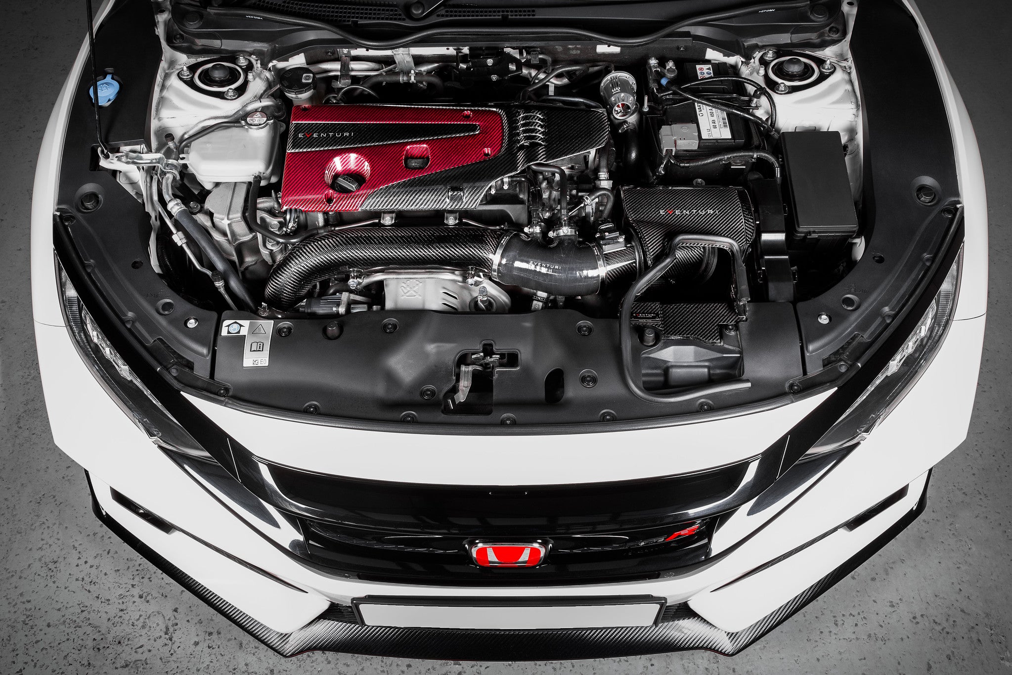 Eventuri FK8 Civic Type-R black carbon intake system installed in engine bay, showcasing its sleek design and performance components