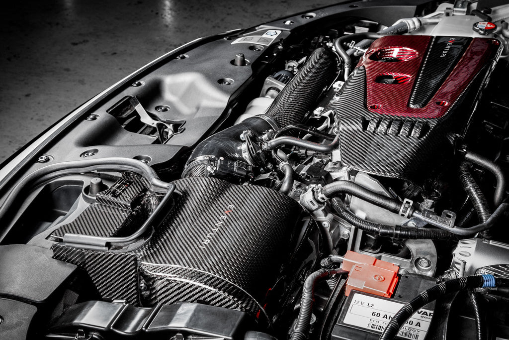 Eventuri FK8 Civic Type-R black carbon intake system installed in engine bay, showcasing sleek performance-oriented design.