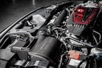 Eventuri FK8 Civic Type-R black carbon intake system installed in engine bay, showcasing sleek performance-oriented design.
