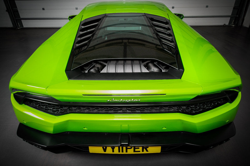 Eventuri Lamborghini Huracan black carbon engine cover set installed in the engine bay, showcasing performance carbon fiber design.