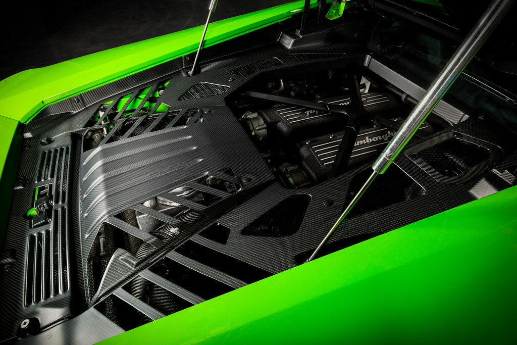 Eventuri Lamborghini Huracan black carbon engine cover set installed in the engine bay, showcasing performance automotive design.