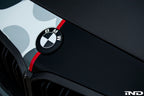 IND Carbon BMW Roundel exterior set featuring sleek, black carbon fiber design with silver accents on a BMW vehicle.