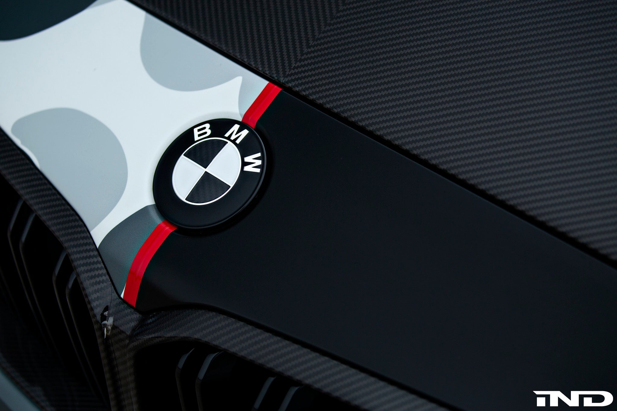 IND Carbon BMW Roundel exterior set featuring sleek, black carbon fiber design with silver accents on a BMW vehicle.
