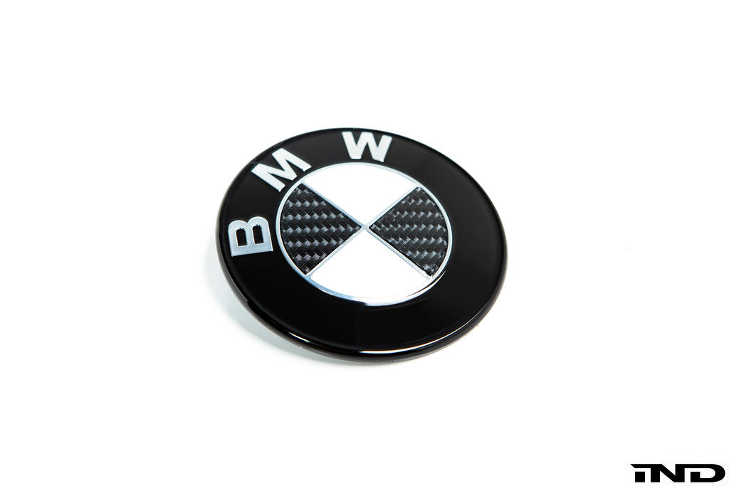 IND Carbon BMW Roundel set for exterior, close-up of black carbon fiber emblems with the iconic BMW logo.