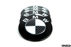 IND Carbon BMW Roundel set for exterior use, featuring sleek black emblems with carbon fiber accents on a white background.