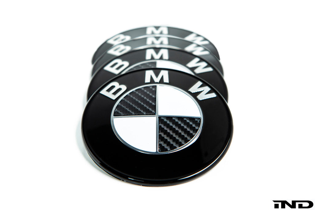 IND Carbon BMW Roundel set for exterior use, featuring sleek black emblems with carbon fiber accents on a white background.
