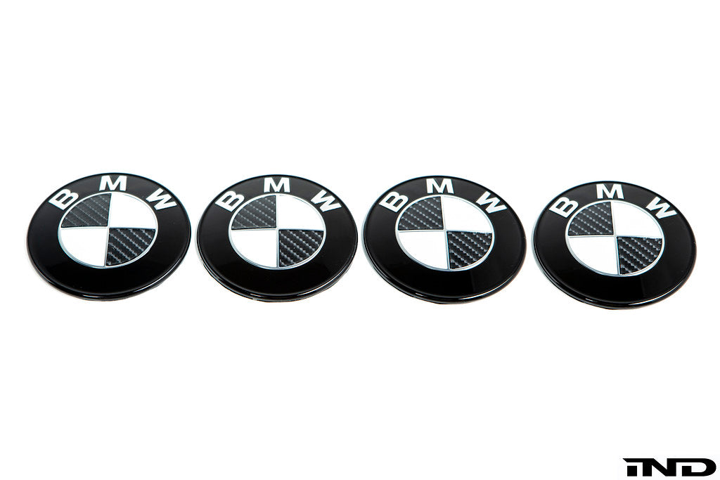 IND Carbon BMW Roundel Set for exterior, featuring sleek black carbon fiber finish and precision detail on the BMW emblem.