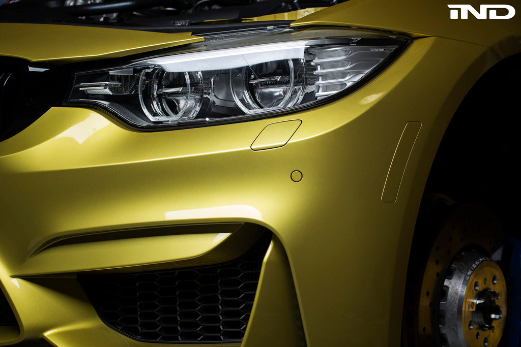 IND F8X M3 M4 painted front reflector set mounted on a vehicle's exterior, showcasing sleek, custom automotive exterior accessories.