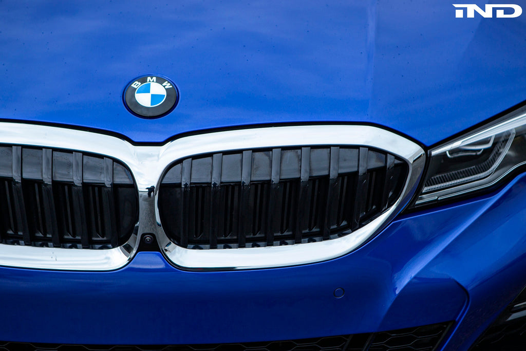 Exterior IND Painted BMW Roundel Set showing sleek, painted BMW logos on a reflective surface.