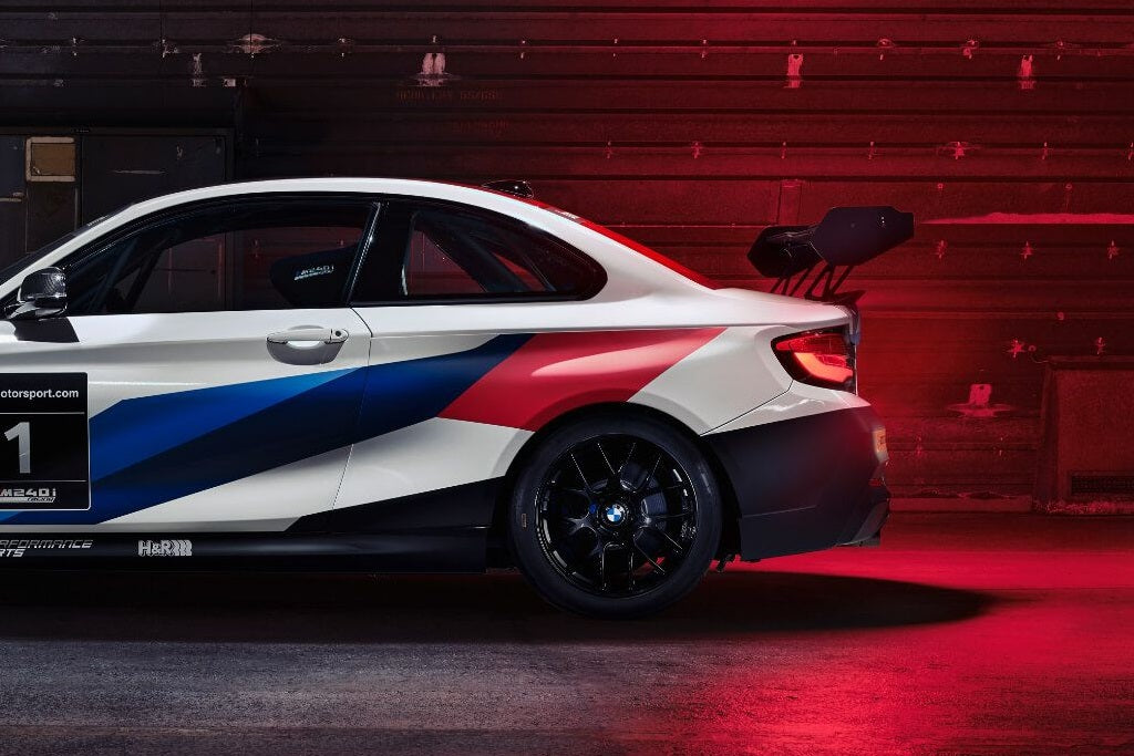 BMW Motorsport M240iR wing endplate set installed on vehicle exterior, showcasing aerodynamic design and branding details.