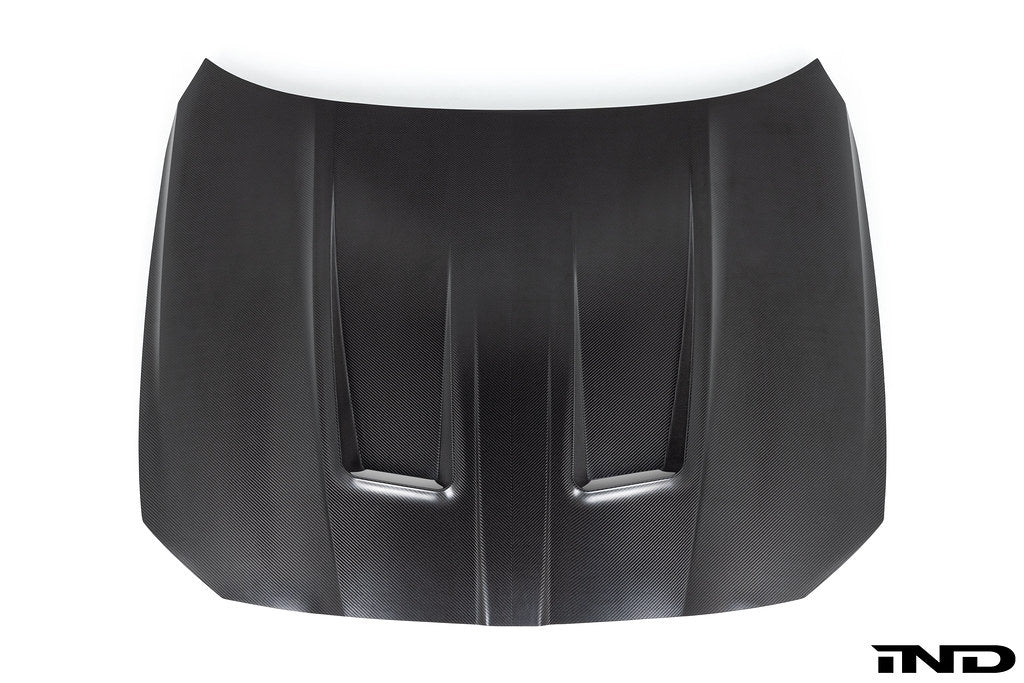 Alpha N G8X M3 M4 carbon fiber vented hood with raw finish, exterior view showing lightweight, aerodynamic design.